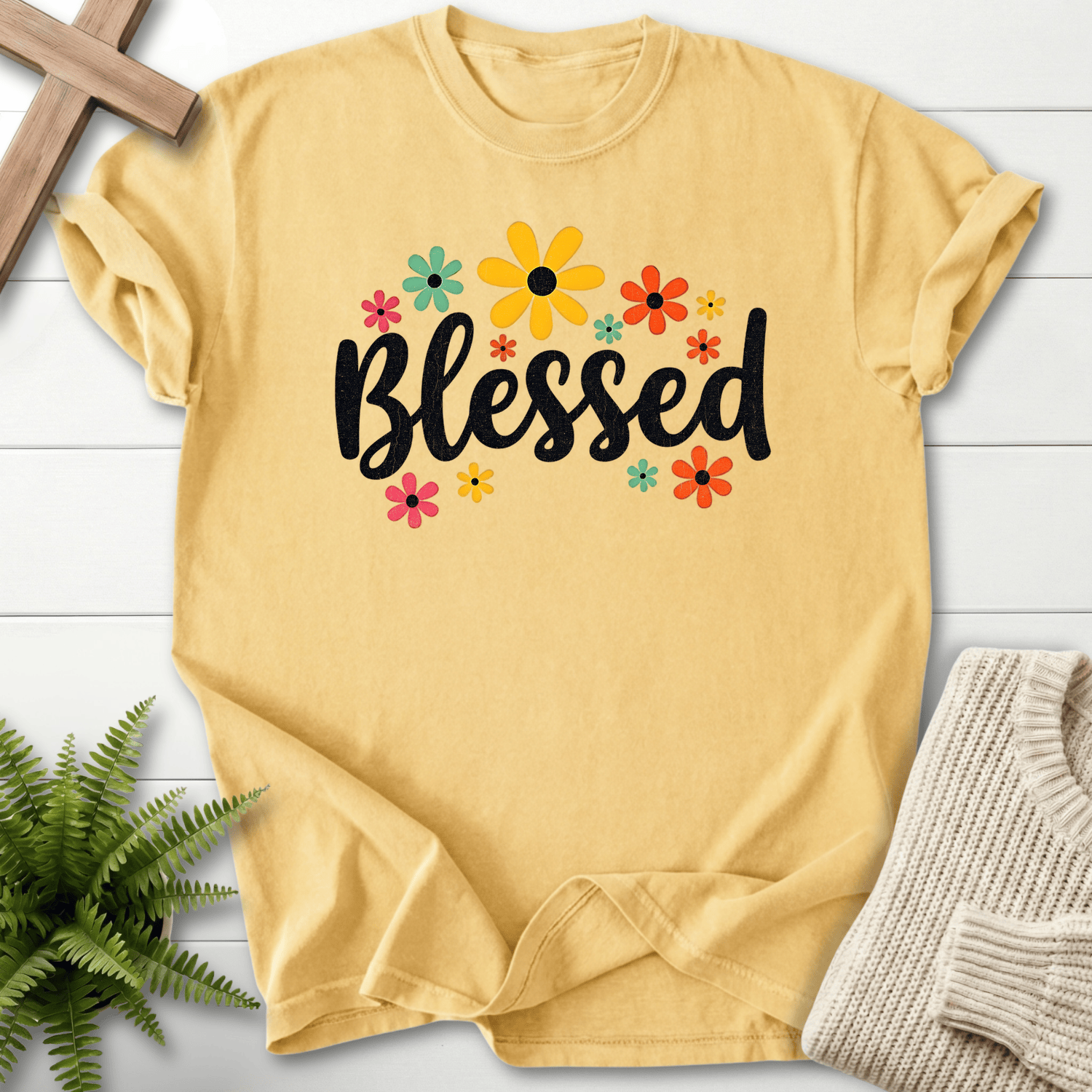 Butter yellow Christian t-shirt for women with a retro floral design featuring pink, teal, and orange daisies.