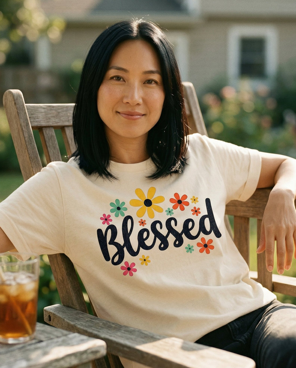 Blessed Floral – Ivory women's Christian tee, lifestyle photo in sunny porch – Retro-style colorful floral design with bright daisy and sunflower acc – She Wears Faith
