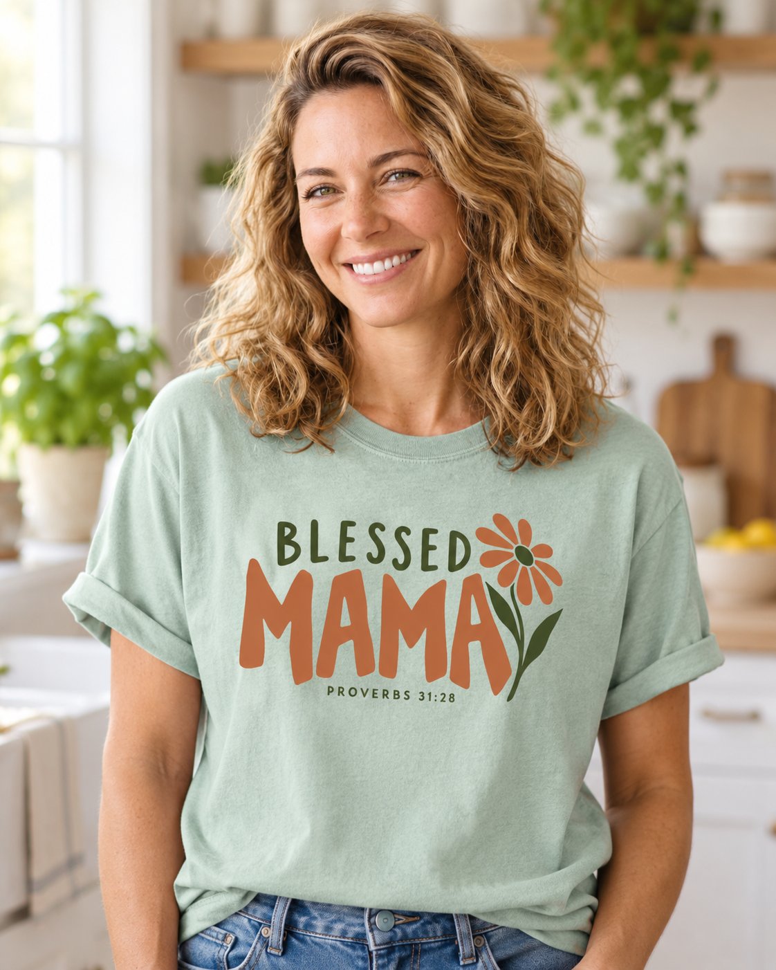 Blessed Mama Proverbs 31 28 – Bay women's Christian tee, lifestyle photo in morning kitchen setting – Terracotta BLESSED MAMA lettering with an orange daisy – She Wears Faith