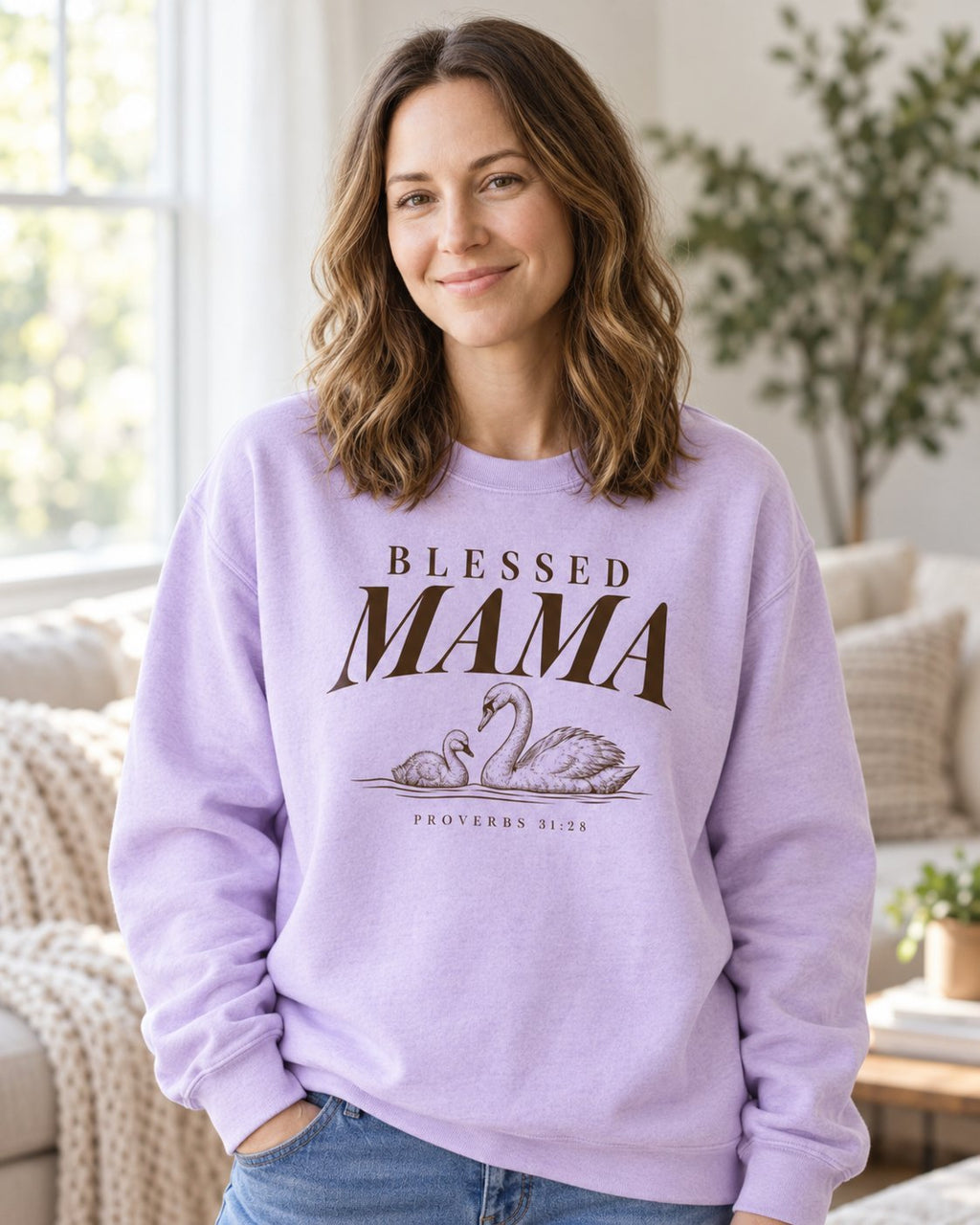 Blessed Mama Swan, Orchid women's Christian sweatshirt, lifestyle photo in cozy living room, Brown BLESSED MAMA lettering with a swan and cygnet, She Wears Faith