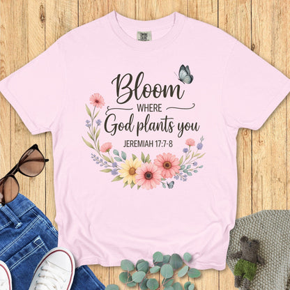 Flatlay of a Comfort Colors 1717 ivory “Bloom Where God Plants You – Jeremiah 17:7-8” t-shirt featuring pastel wildflowers and butterflies. A soft and feminine women’s scripture tee — modern Christian shirt and uplifting faith-based apparel for women, perfect Christian mom gift idea.