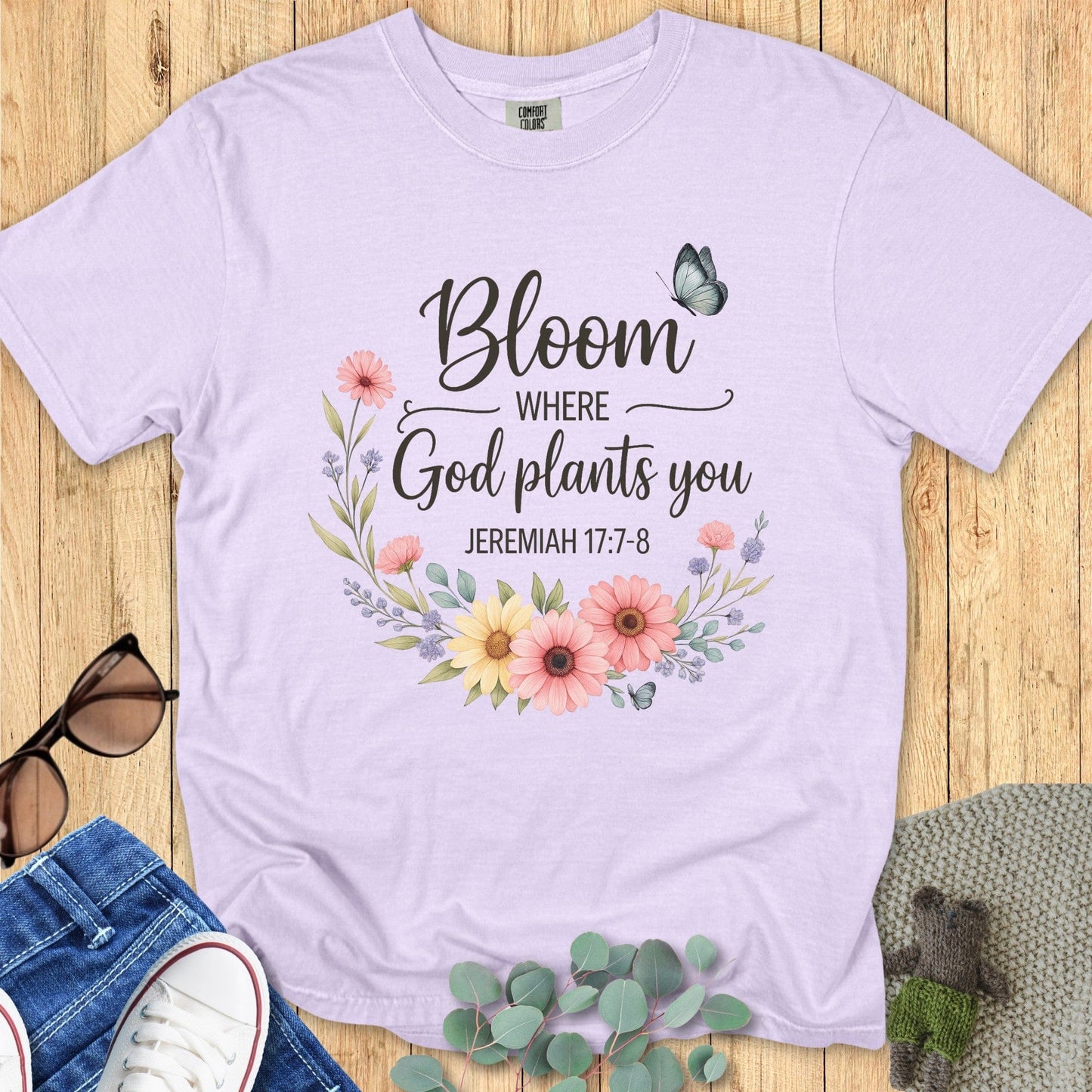 Comfort Colors 1717 orchid “Bloom Where God Plants You – Jeremiah 17:7-8” t-shirt with watercolor-style flowers and butterfly design. A gentle and inspiring women’s scripture tee — faith-based apparel for women and beautiful modern Christian shirt for moms or friends of faith.