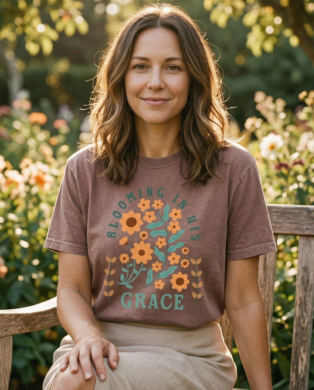 Blooming in His Grace – Espresso women's Christian tee, lifestyle photo in outdoor garden – Retro botanical illustration with orange sunflowers and teal leaves ar – She Wears Faith