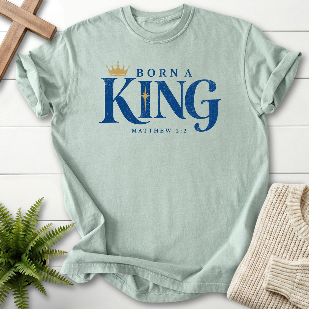 Flat lay of a Bay Christian shirt featuring "Born a King T-Shirt" Matthew 2:2 For faith wear collections.