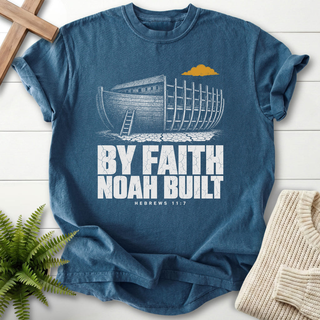 Flatlay of a Midnight Comfort Colors 1717 faith-inspired shirt with "By Faith Noah Built Hebrews 11 7 T-Shirt" Hebrews 11:7.
