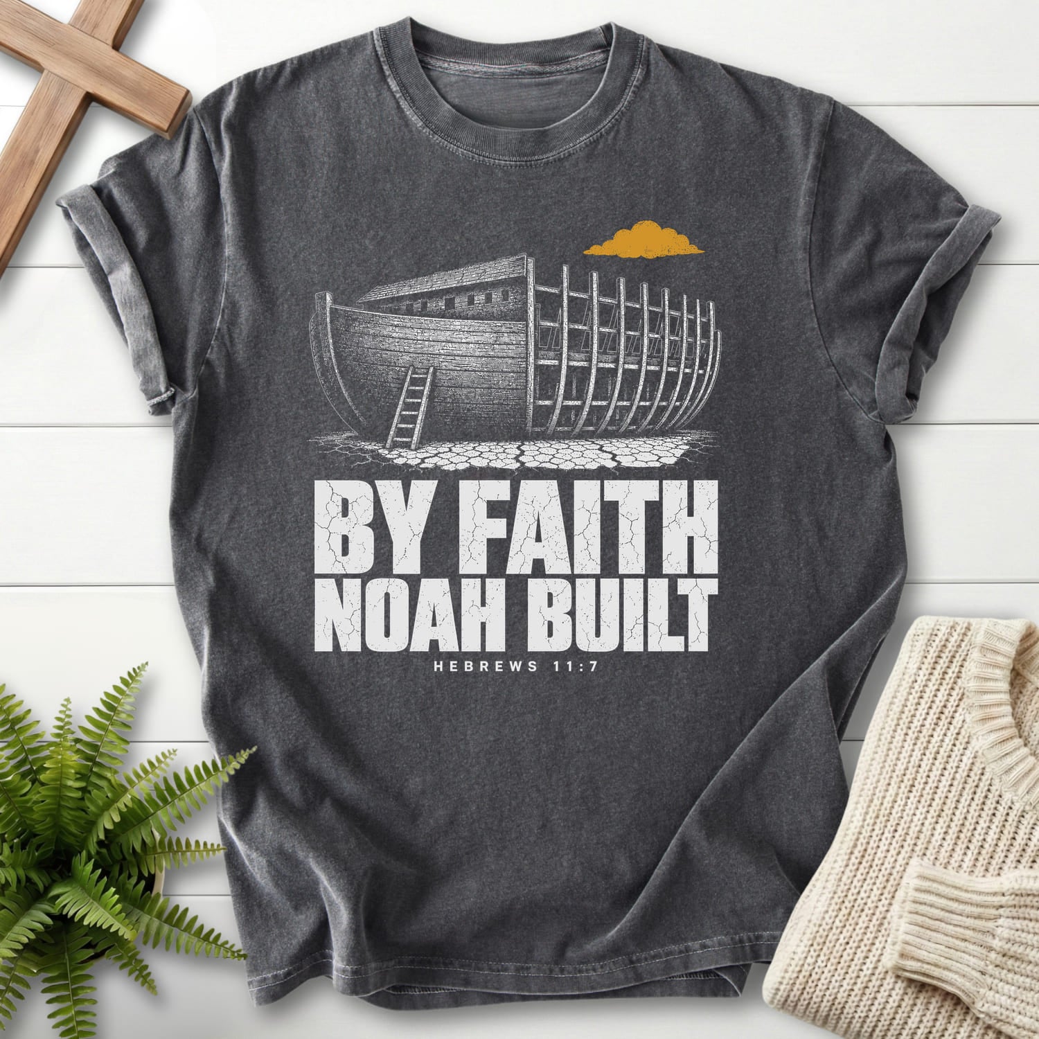 Flat lay of a Pepper Comfort Colors 1717 Christian t-shirt for women featuring "By Faith Noah Built Hebrews 11 7 T-Shirt" Hebrews 11:7 From Printify.