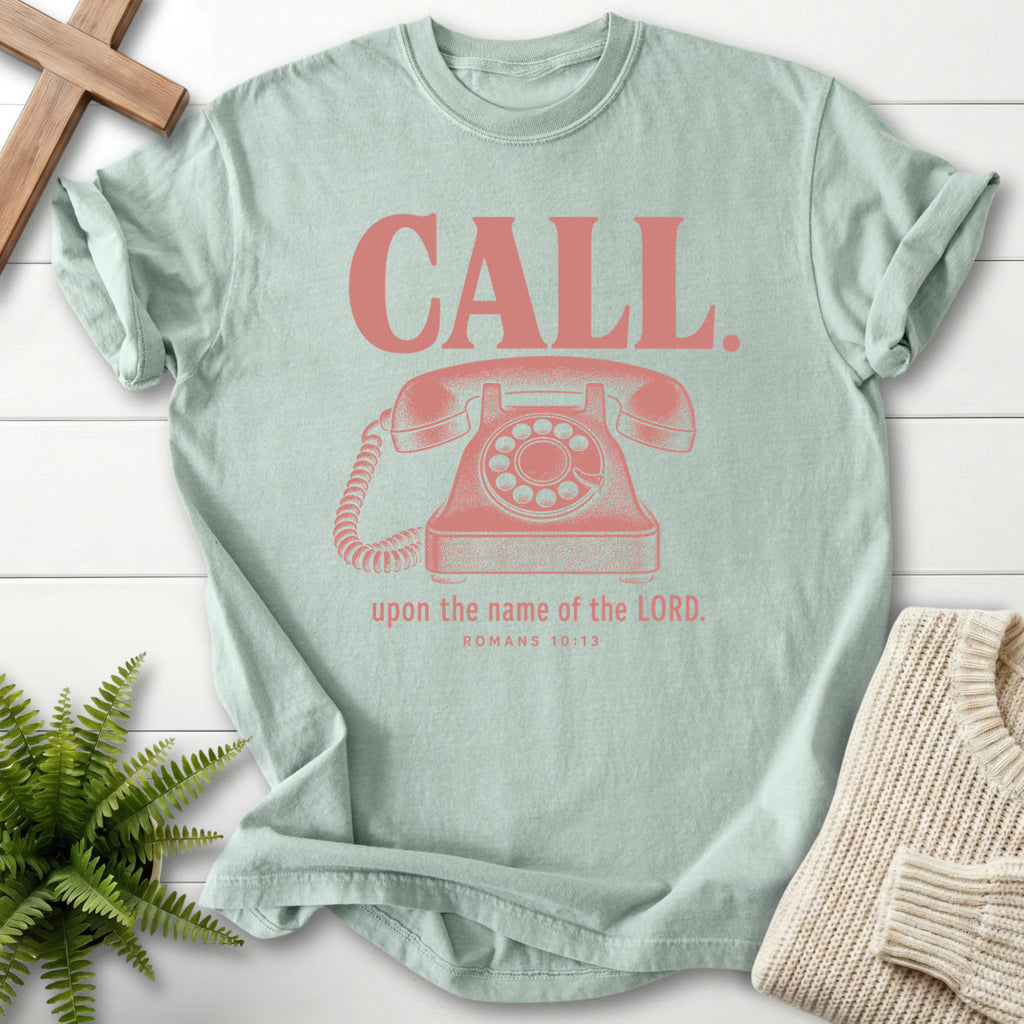 Flat lay of a Bay women's Christian tee featuring "Call Upon the Name of the Lord T-Shirt" Romans 10:13.