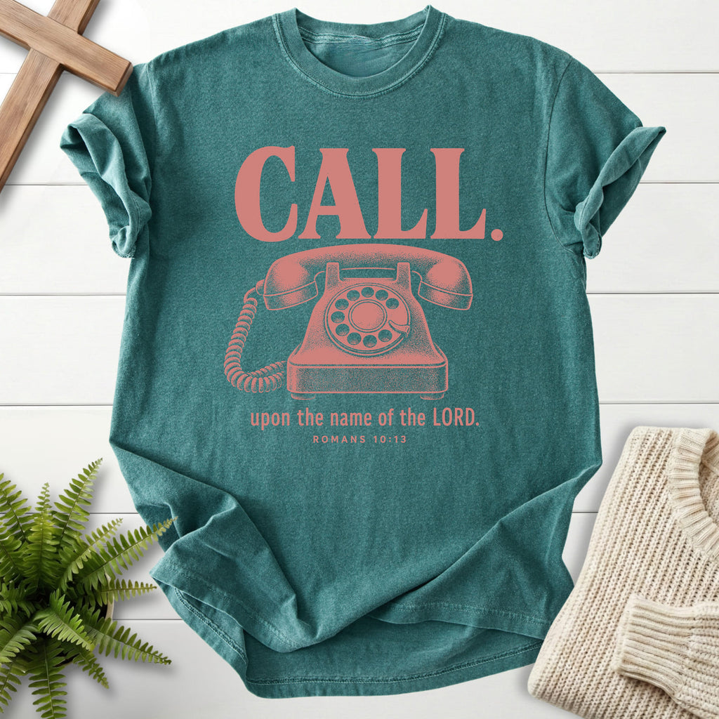 Flatlay of a Blue Spruce faith-inspired shirt with "Call Upon the Name of the Lord T-Shirt" Romans 10:13.
