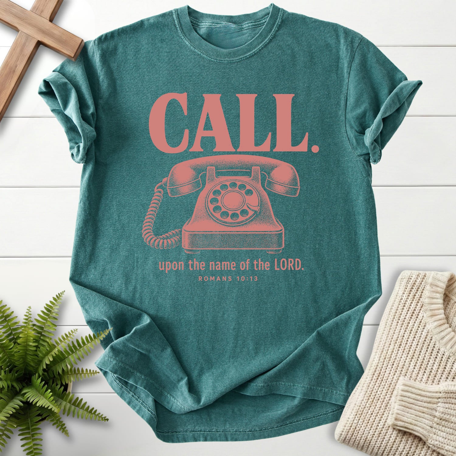 Flatlay of a Blue Spruce faith-inspired shirt with "Call Upon the Name of the Lord T-Shirt" Romans 10:13.