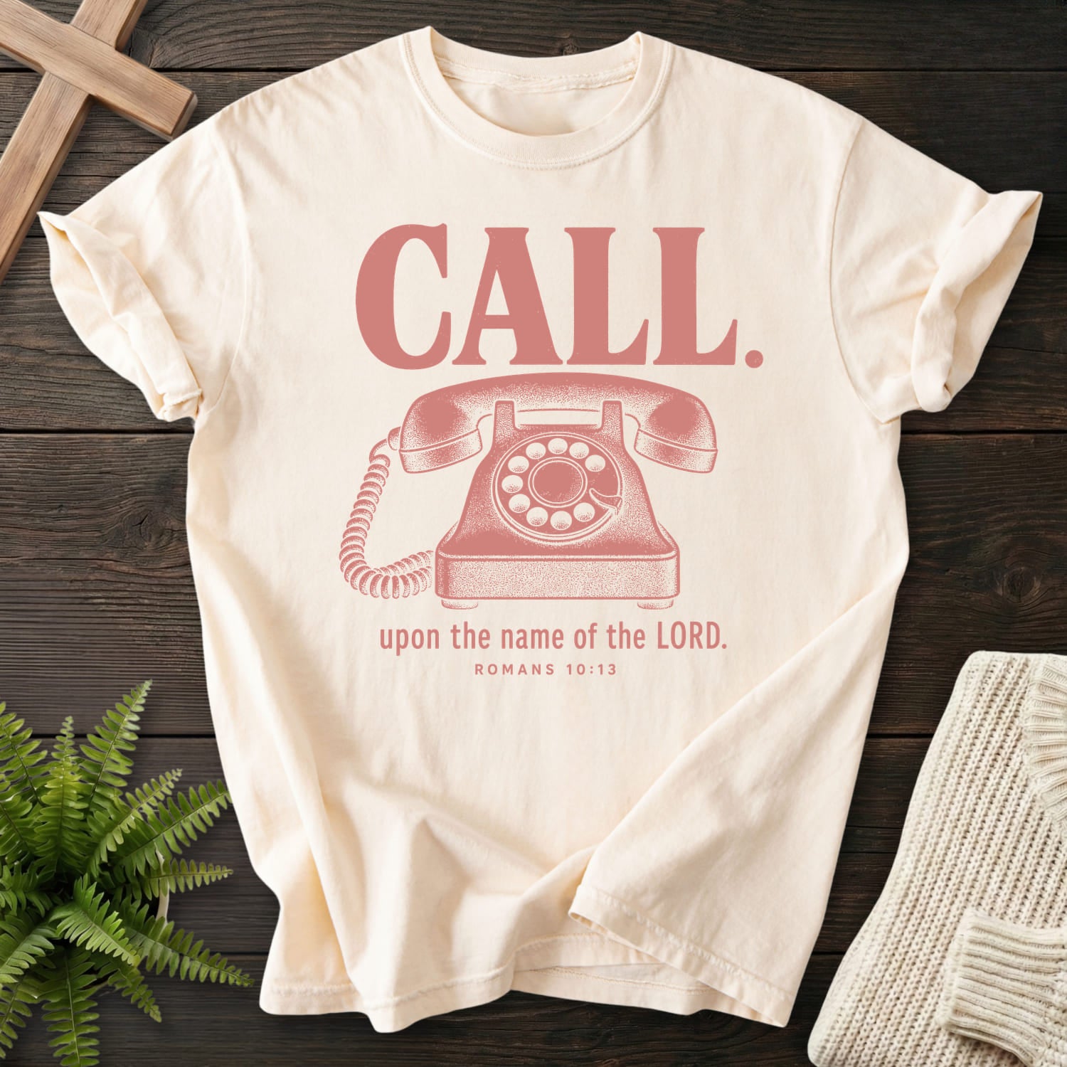 Flat lay of an Ivory Comfort Colors 1717 Christian t-shirt for women featuring "Call Upon the Name of the Lord T-Shirt" Romans 10:13 From Printify.