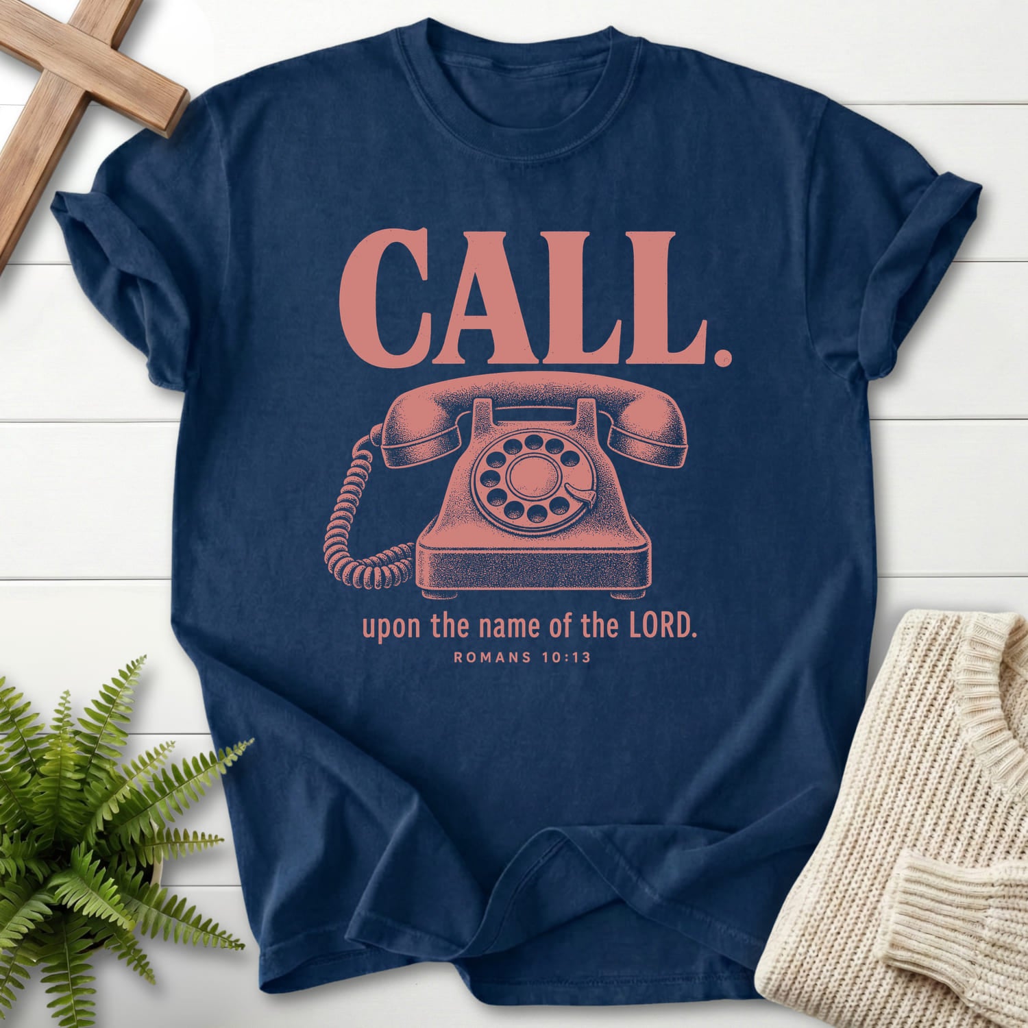 Flatlay of a Navy faith-based tee with "Call Upon the Name of the Lord T-Shirt" Romans 10:13.