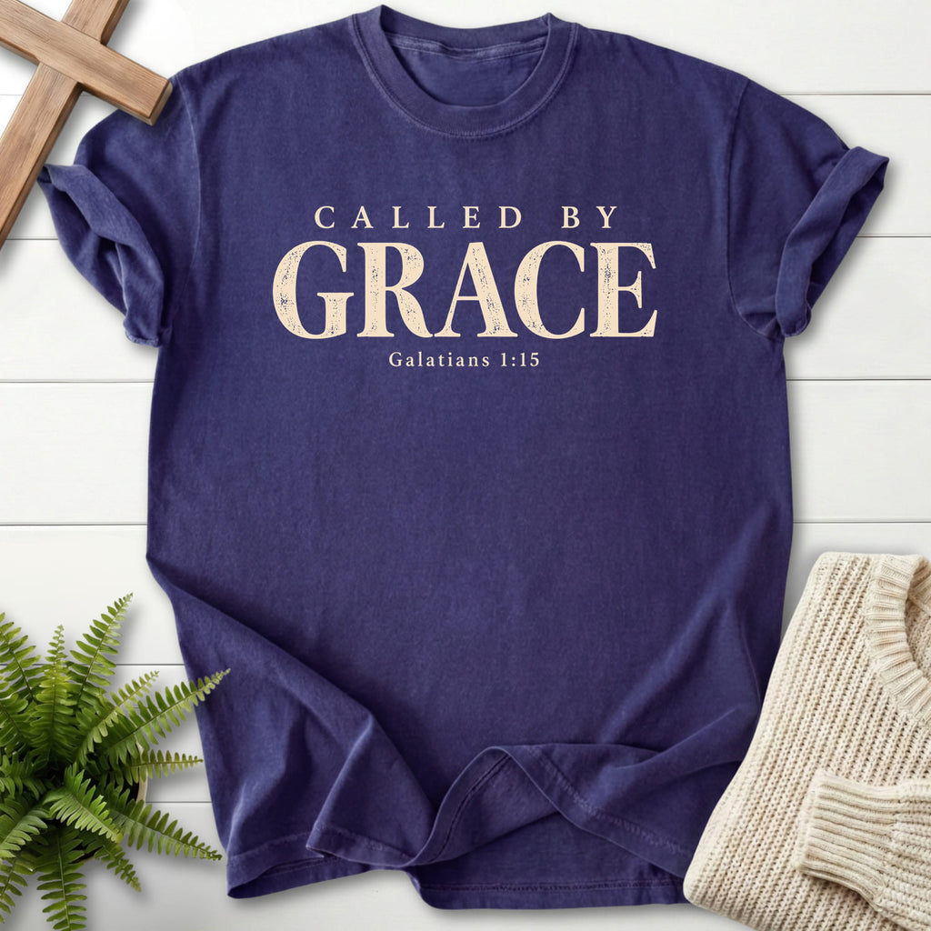 Flat lay of a Grape Christian shirt featuring "Called by Grace T-Shirt" Galatians 1:15.