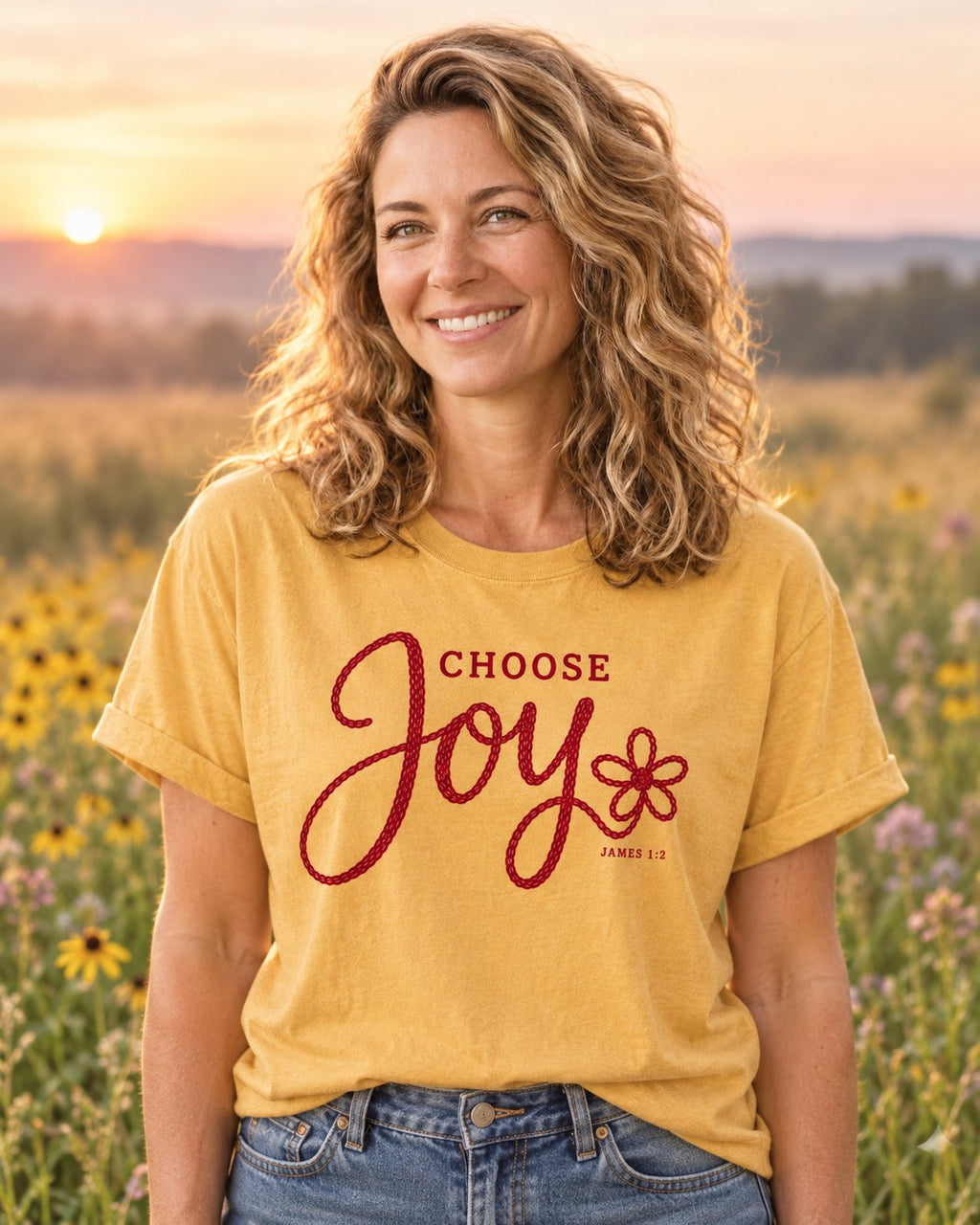 Choose Joy Knitted Lettering, Mustard women's Christian tee, lifestyle photo in wildflower meadow at sunrise, Red knitted style CHOOSE Joy script with a flower, She Wears Faith