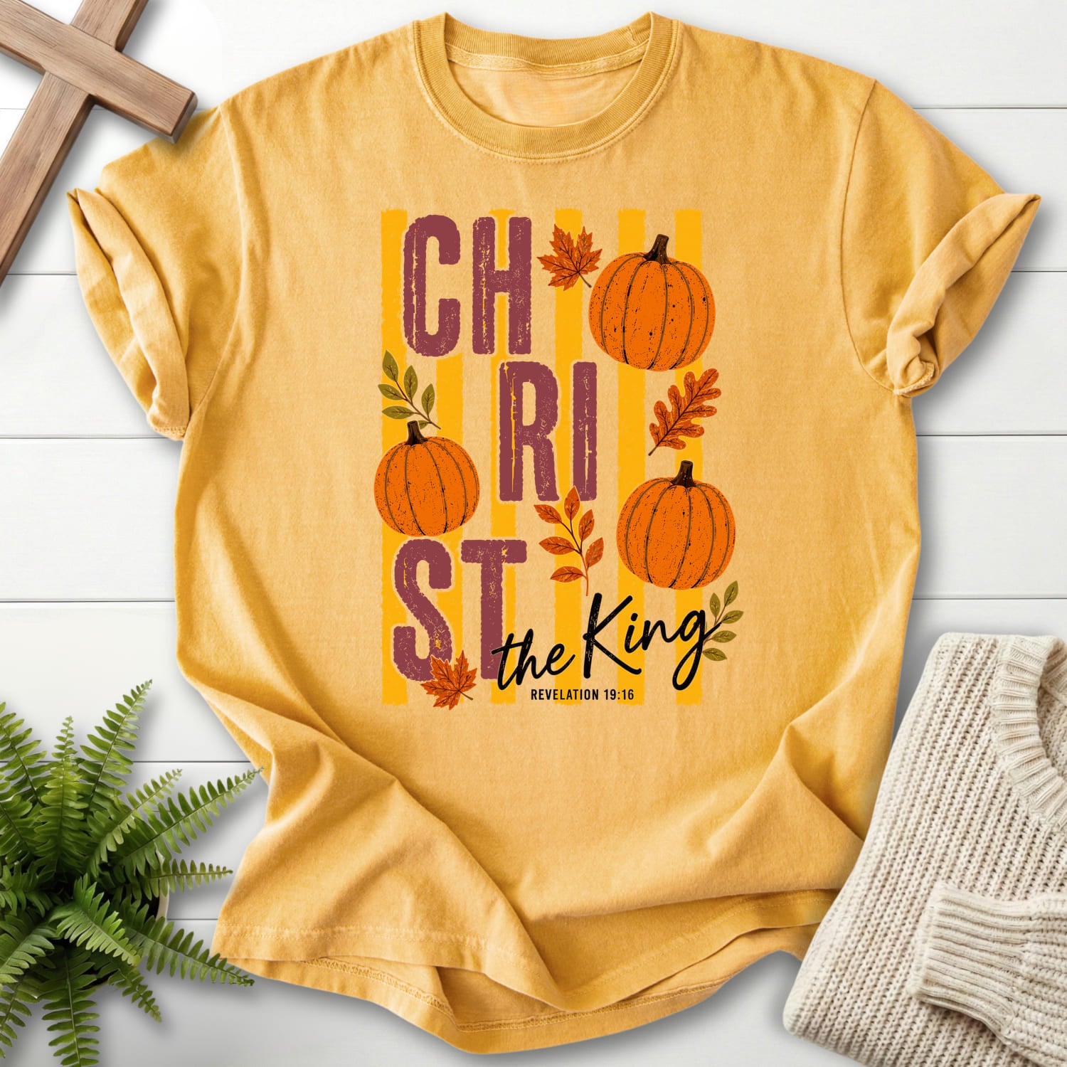 Mustard color option for the Christ The King Fall Scripture shirt with script typography with "Christ The King Fall T-Shirt" Revelation 1:16.