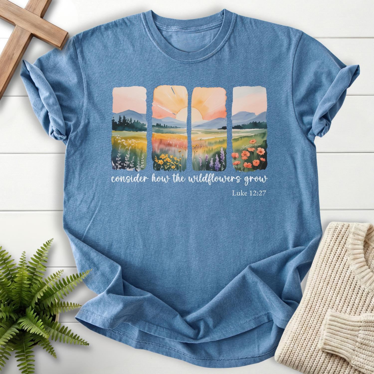 Blue Jean Christian t-shirt for women with four watercolor meadow landscape panels, inspired by Luke 12:27.