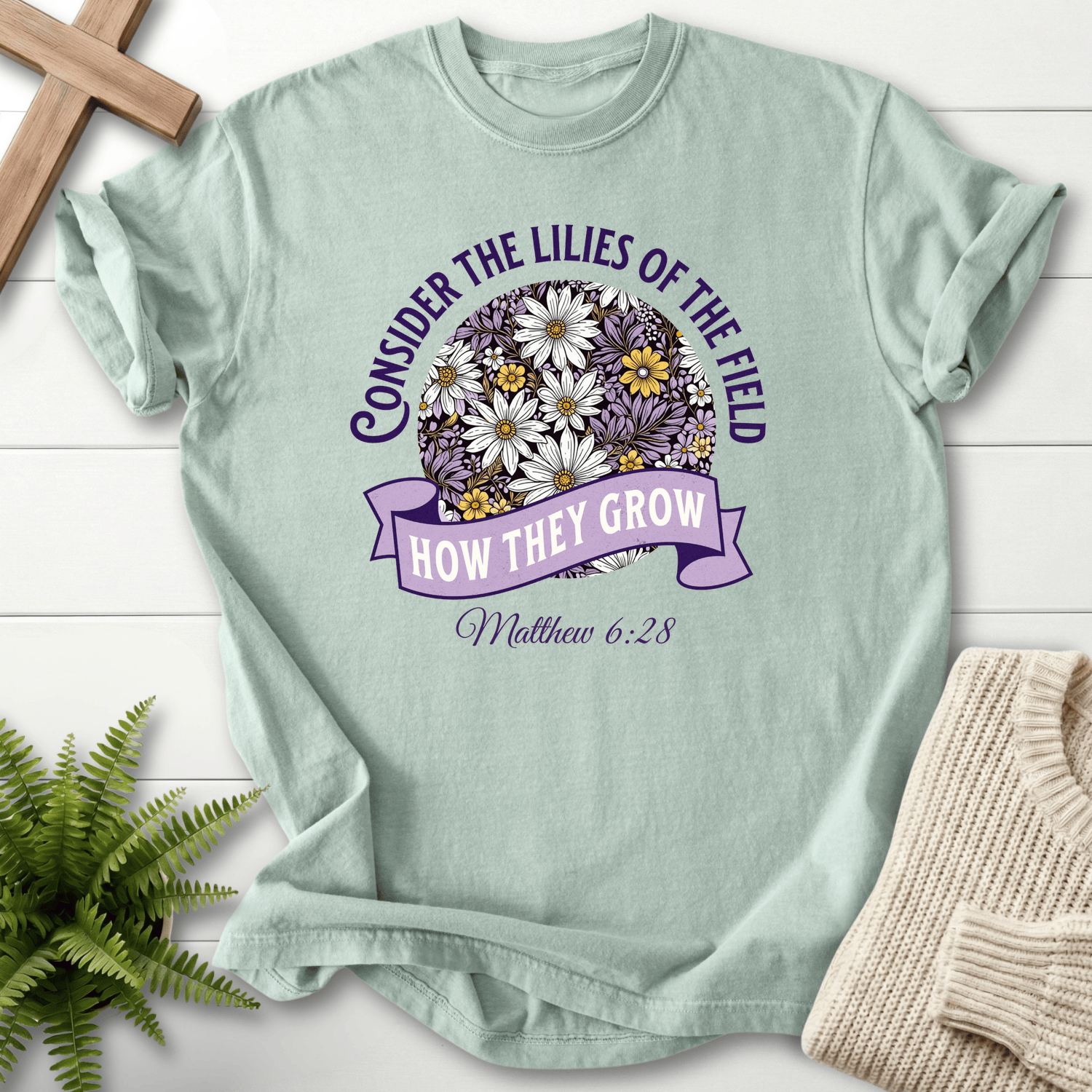 Bay Christian t-shirt for women with a circular botanical badge, inspired by Matthew 6:28.