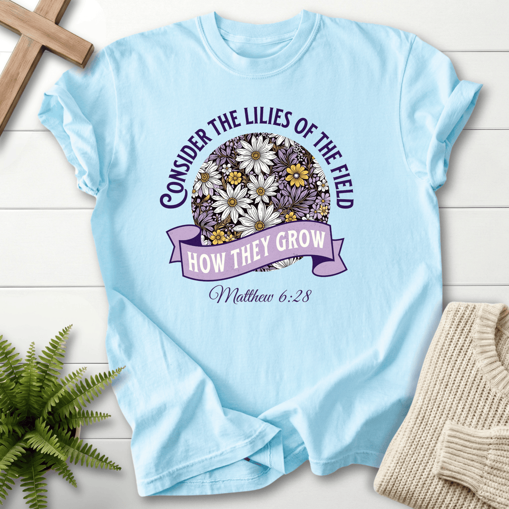 Chambray Christian t-shirt for women with a bold circular floral illustration, inspired by Matthew 6:28.