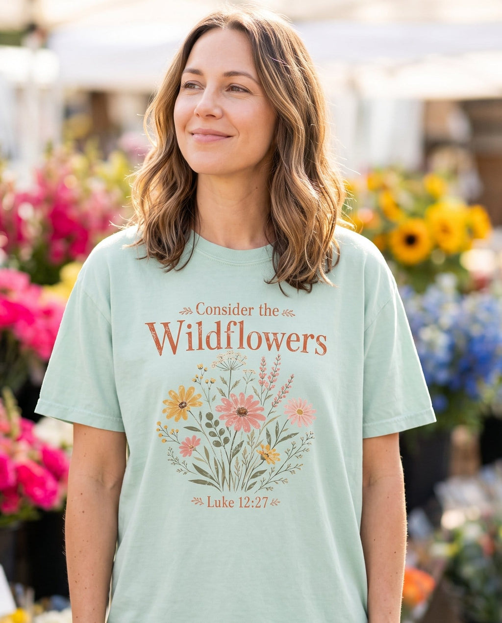 Consider the Wildflowers Boho - Bay women's Christian tee, lifestyle photo in farmers market - Terracotta serif lettering 'Consider the Wildflowers' above a boho bou - Luke 12:27 - She Wears Faith