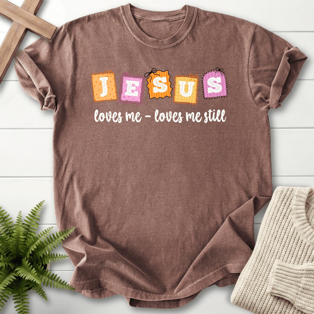 Espresso women's Christian t-shirt with a playful "Jesus loves me still" patchwork letter design
