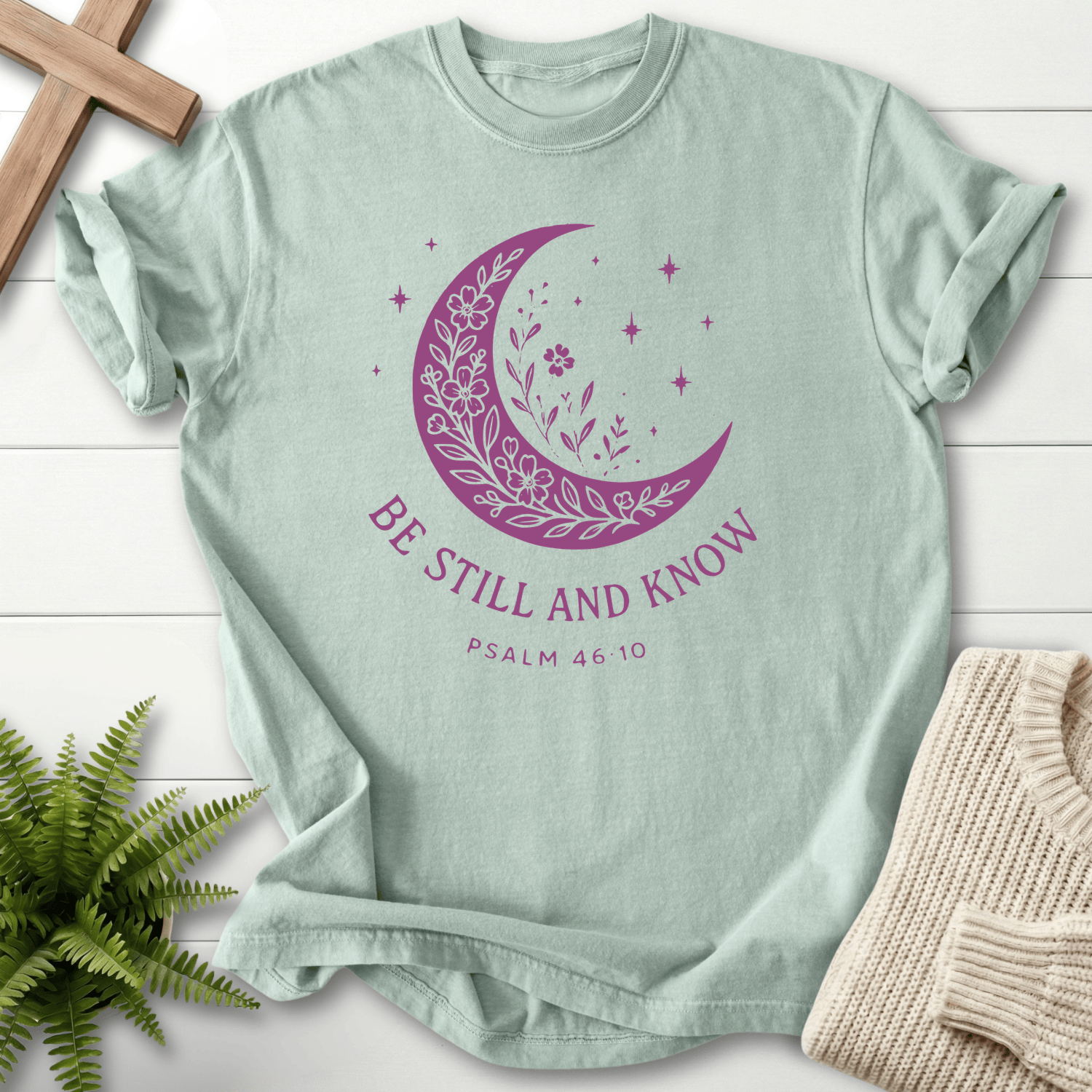 Bay women's faith t-shirt with a floral moon and star motif, inspired by Psalm 46:10.