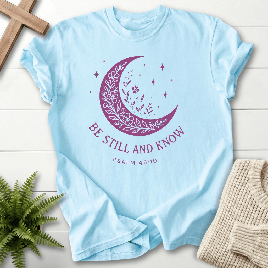 Chambray Christian t-shirt for women with a botanical moon and stars illustration and 'Be Still and Know', Psalm 46:10.