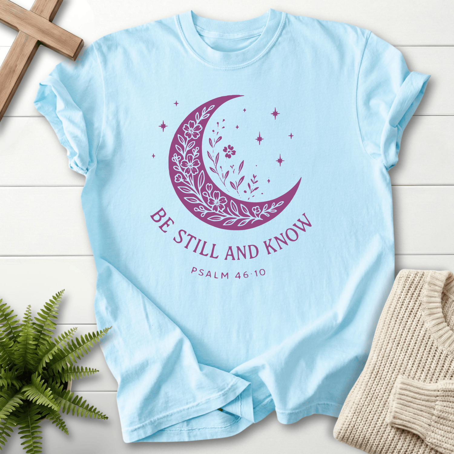 Chambray Christian t-shirt for women with a botanical moon and stars illustration and 'Be Still and Know', Psalm 46:10.