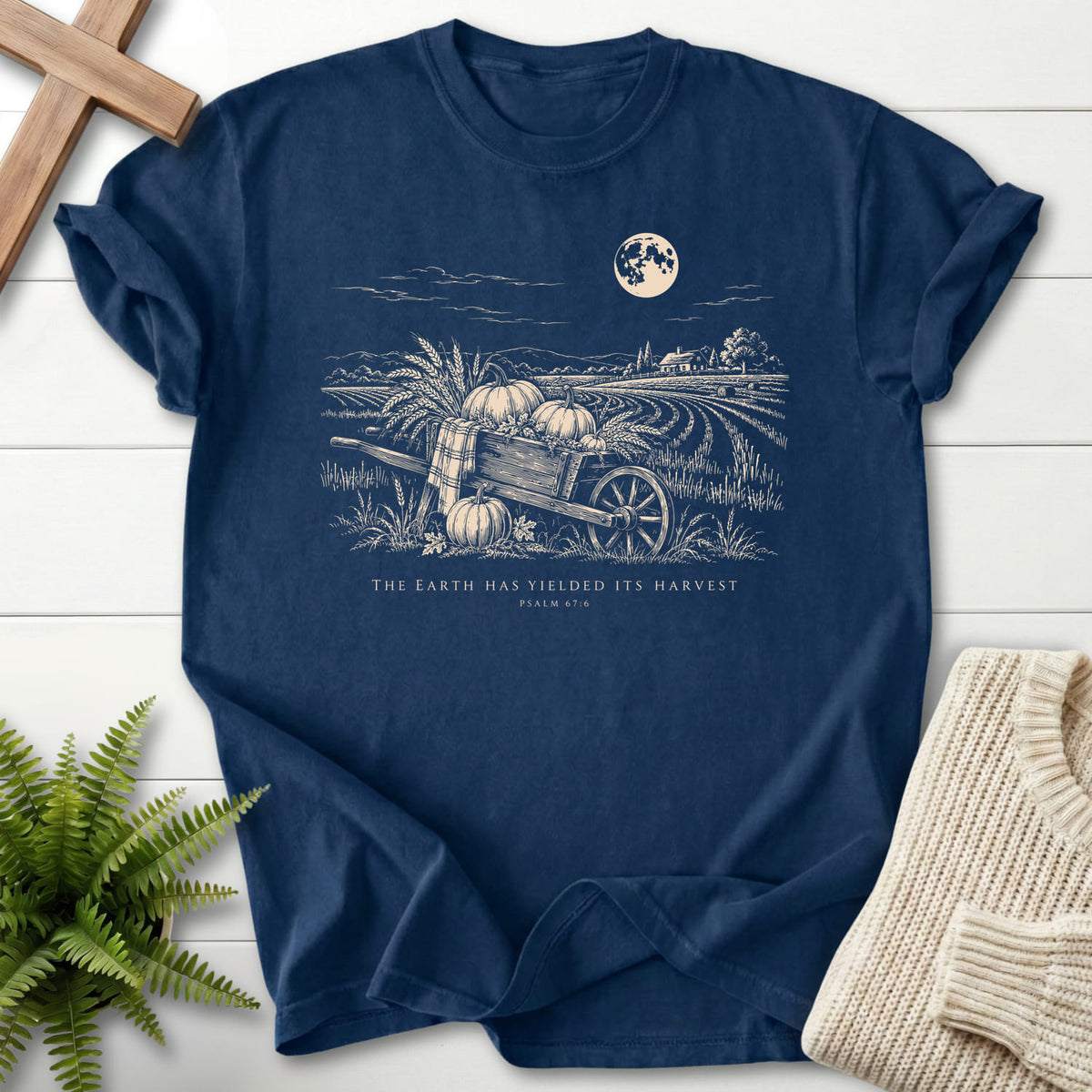 Flat lay of a Navy women's Christian tee featuring mountain graphic with "Earth Has Yielded Its Harvest T-Shirt".