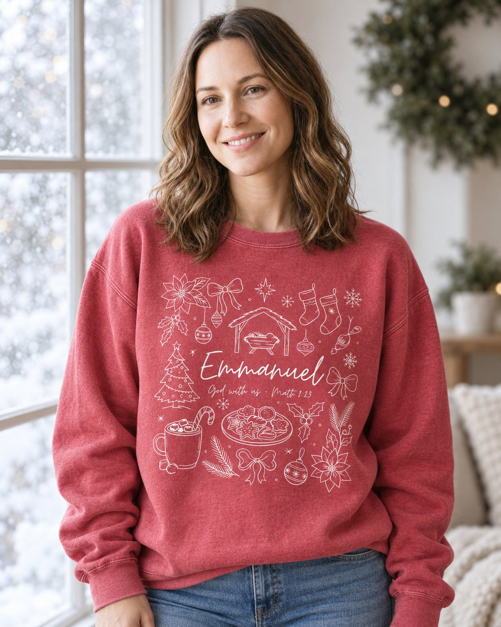 Emmanuel Christmas, Crimson women's Christian sweatshirt, lifestyle photo in cozy holiday setting, White line art Christmas doodles around Emmanuel, She Wears Faith