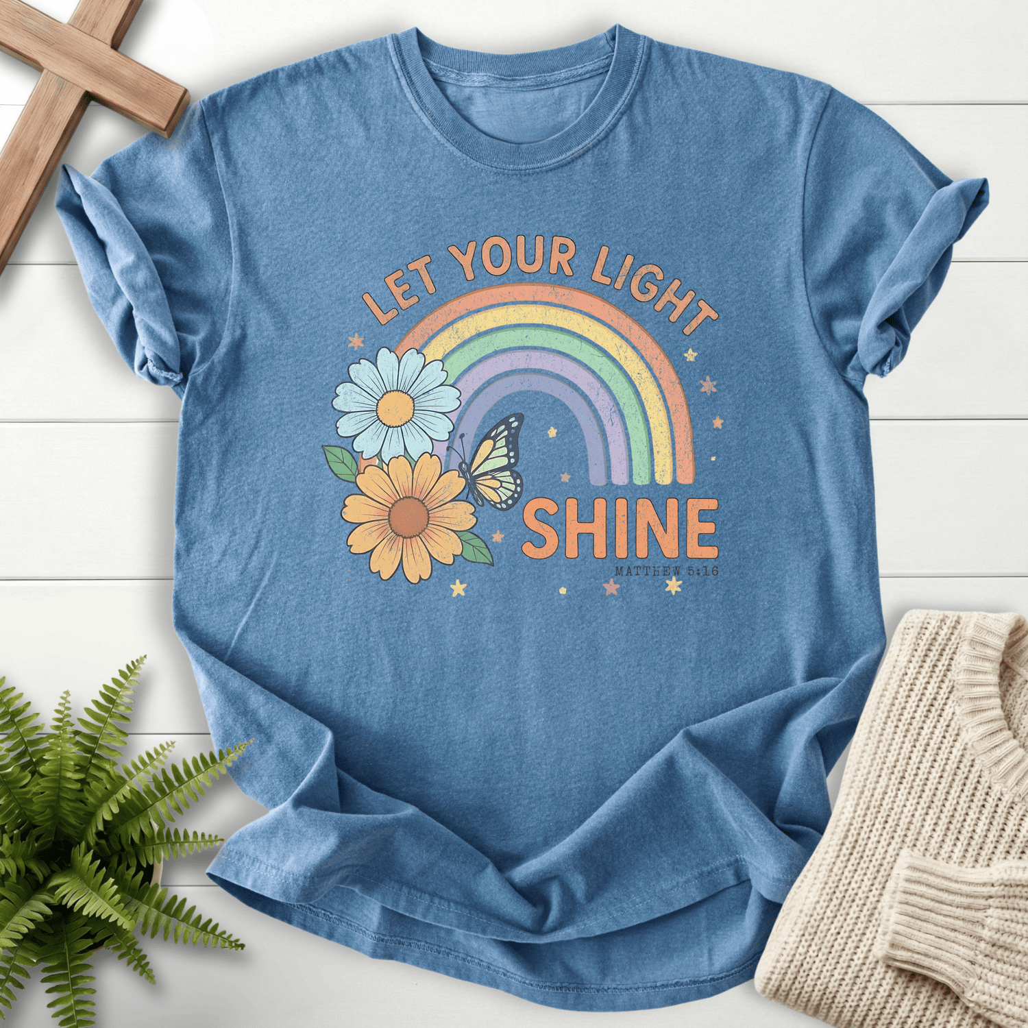 Blue Jean women's Christian t-shirt with groovy rainbow, sunflower, and butterfly design, inspired by Matthew 5:16.