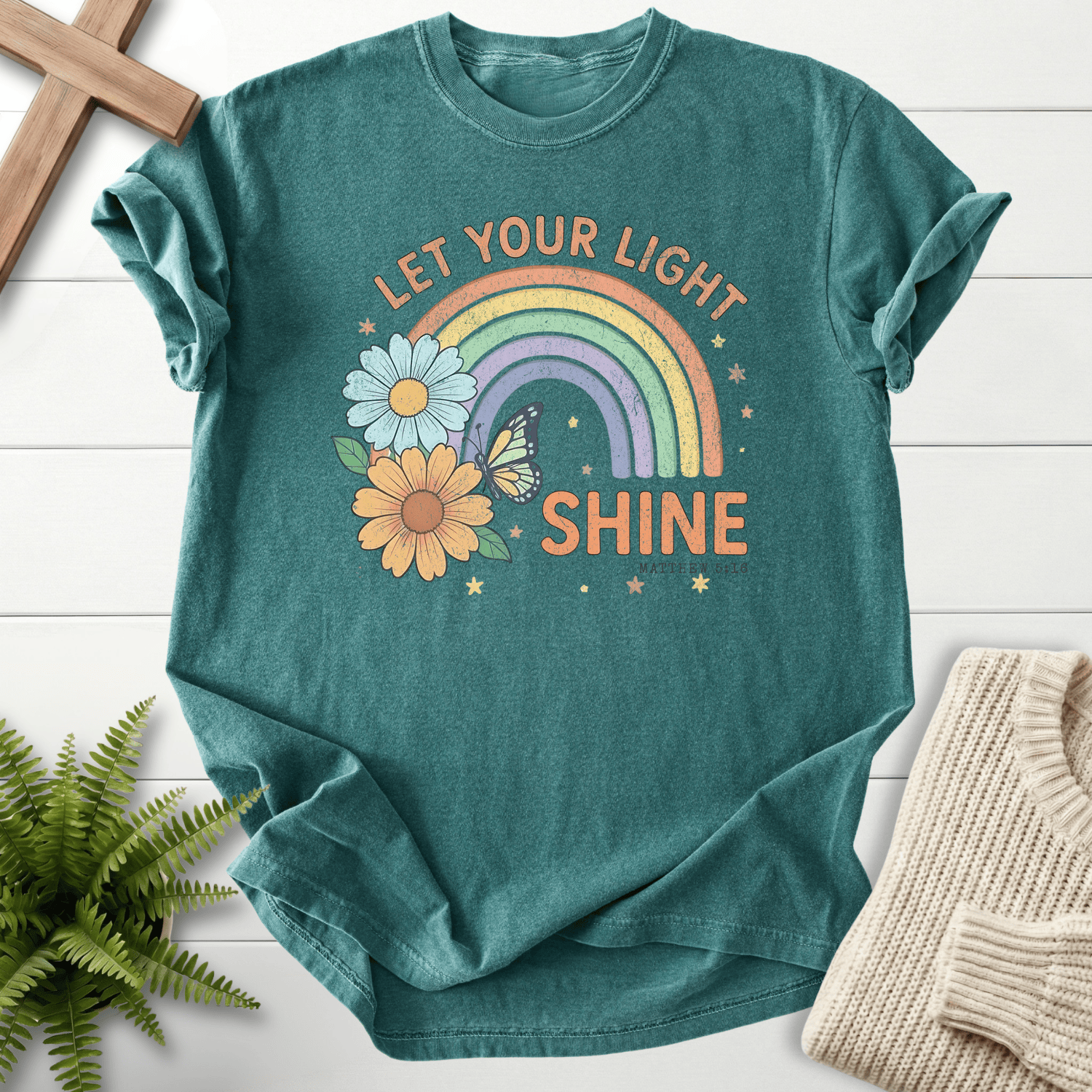 Blue Spruce women's Christian t-shirt with retro rainbow, daisies, and butterfly, inspired by Matthew 5:16.