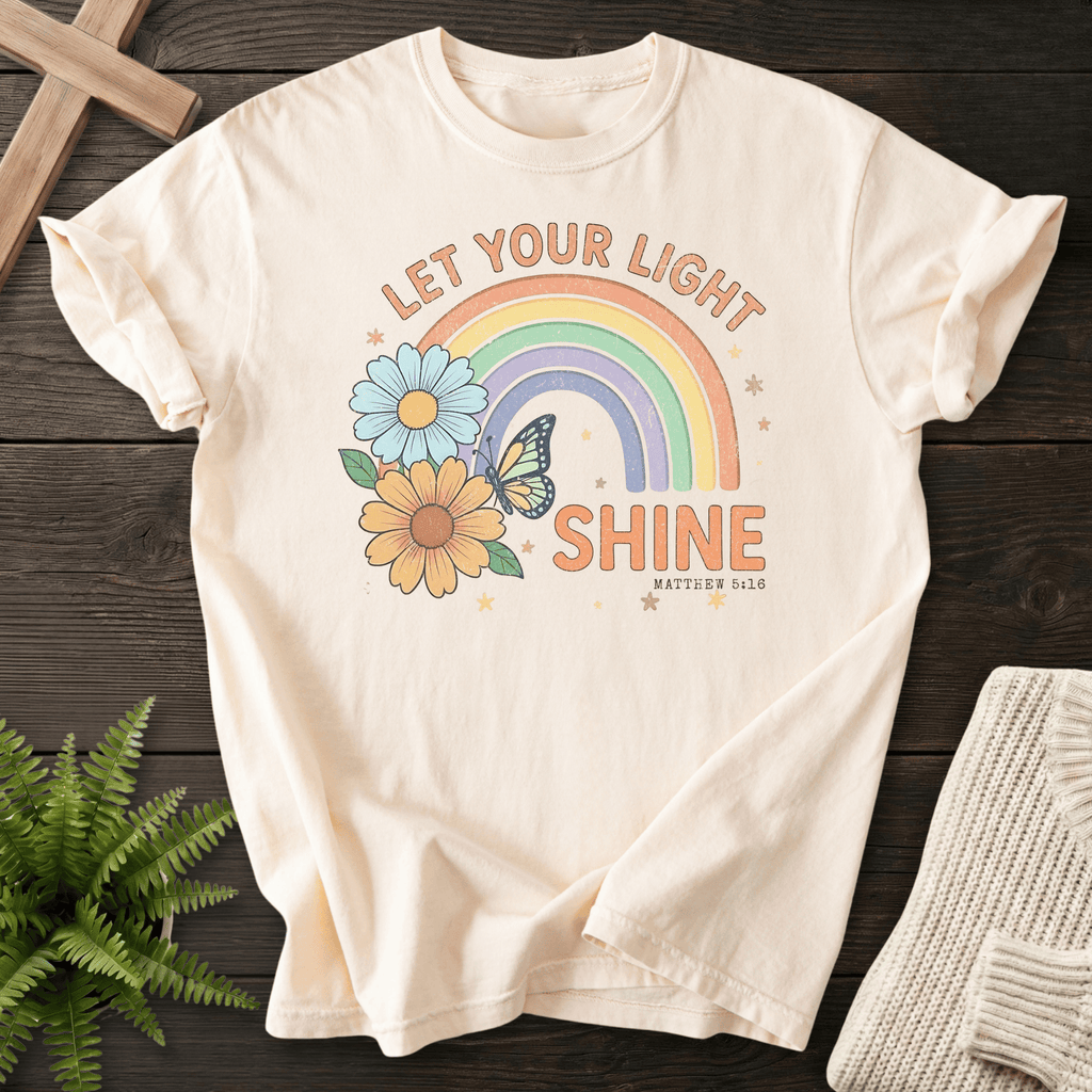 Ivory women's faith t-shirt with pastel rainbow and wildflower graphic, inspired by Matthew 5:16.