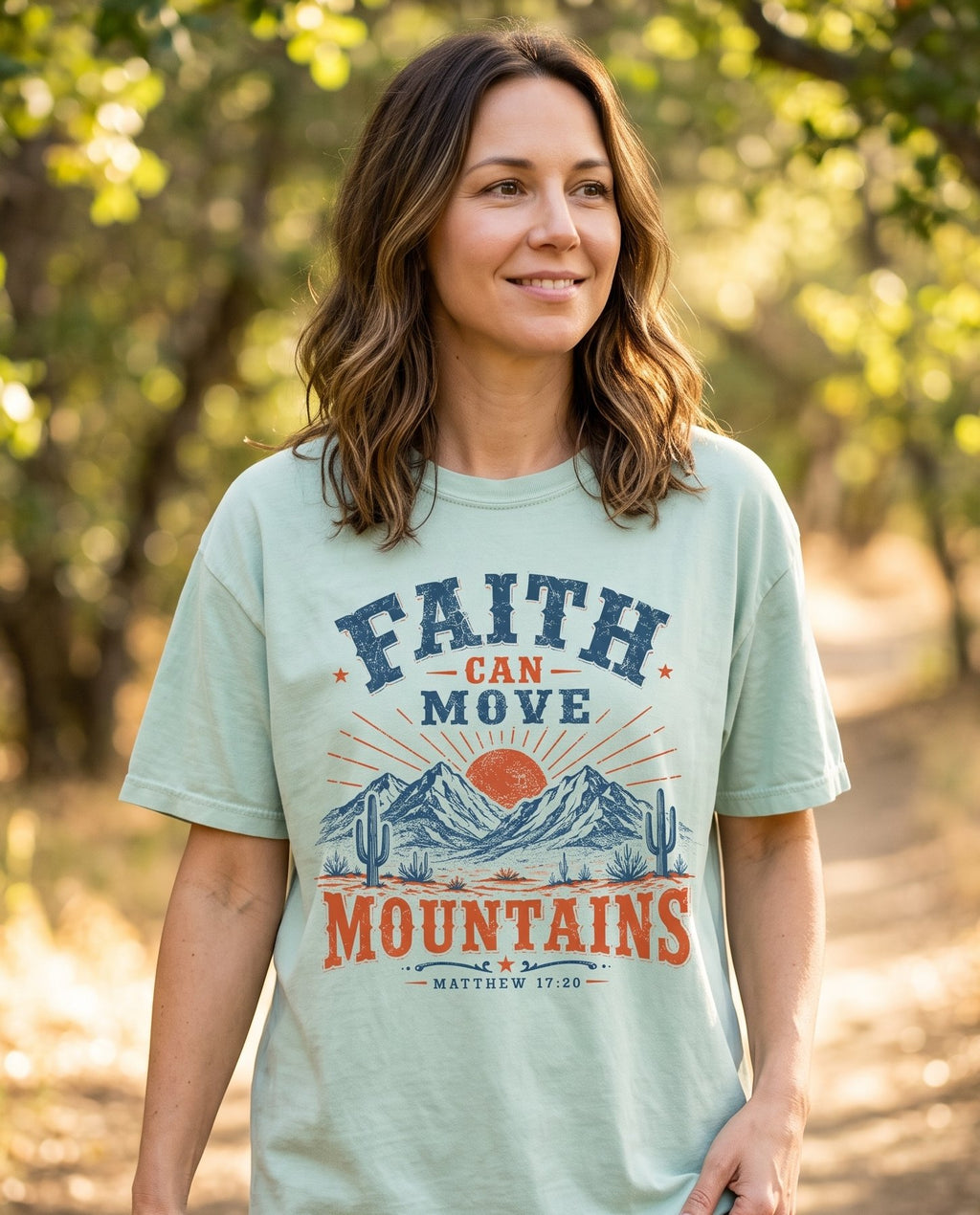 Faith Can Move Mountains Matt 17:20 – Bay women's Christian tee, lifestyle photo in nature trail – Vintage western-style badge with navy and burnt-orange lettering FAITH – Matthew 17:20 – She Wears Faith
