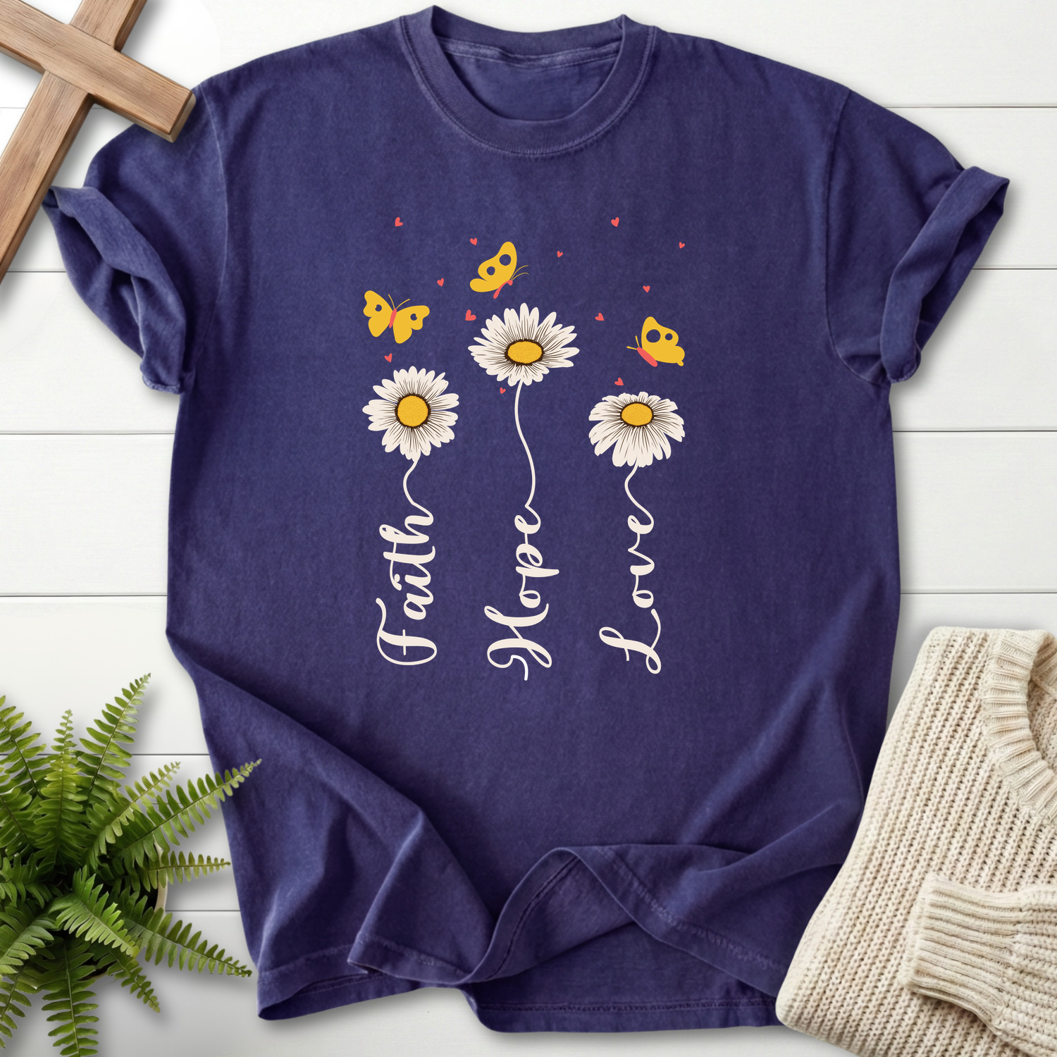 Grape Christian t-shirt for women with a daisy and butterfly illustration in white and yellow.