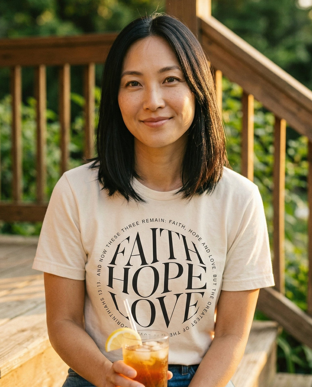 Faith Hope Love Minimalist T-shirt – Ivory women's Christian tee, lifestyle photo in sunny porch – Bold circular minimalist design with large stacked 'FAITH HOPE LOVE' l – 1 Corinthians 13:13 – She Wears Faith