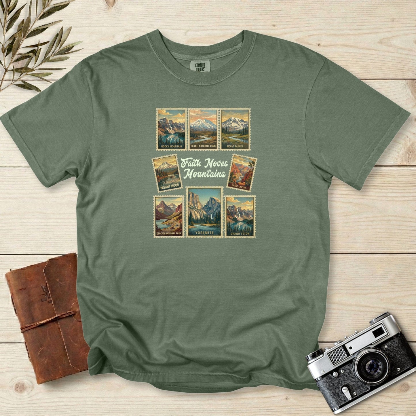 Comfort Colors 1717 moss Christian women tee showcasing vintage national park stamps and the message ‘Faith Moves Mountains.’ Outdoor travel themed Christian tshirt for US faith wear and adventure enthusiasts.