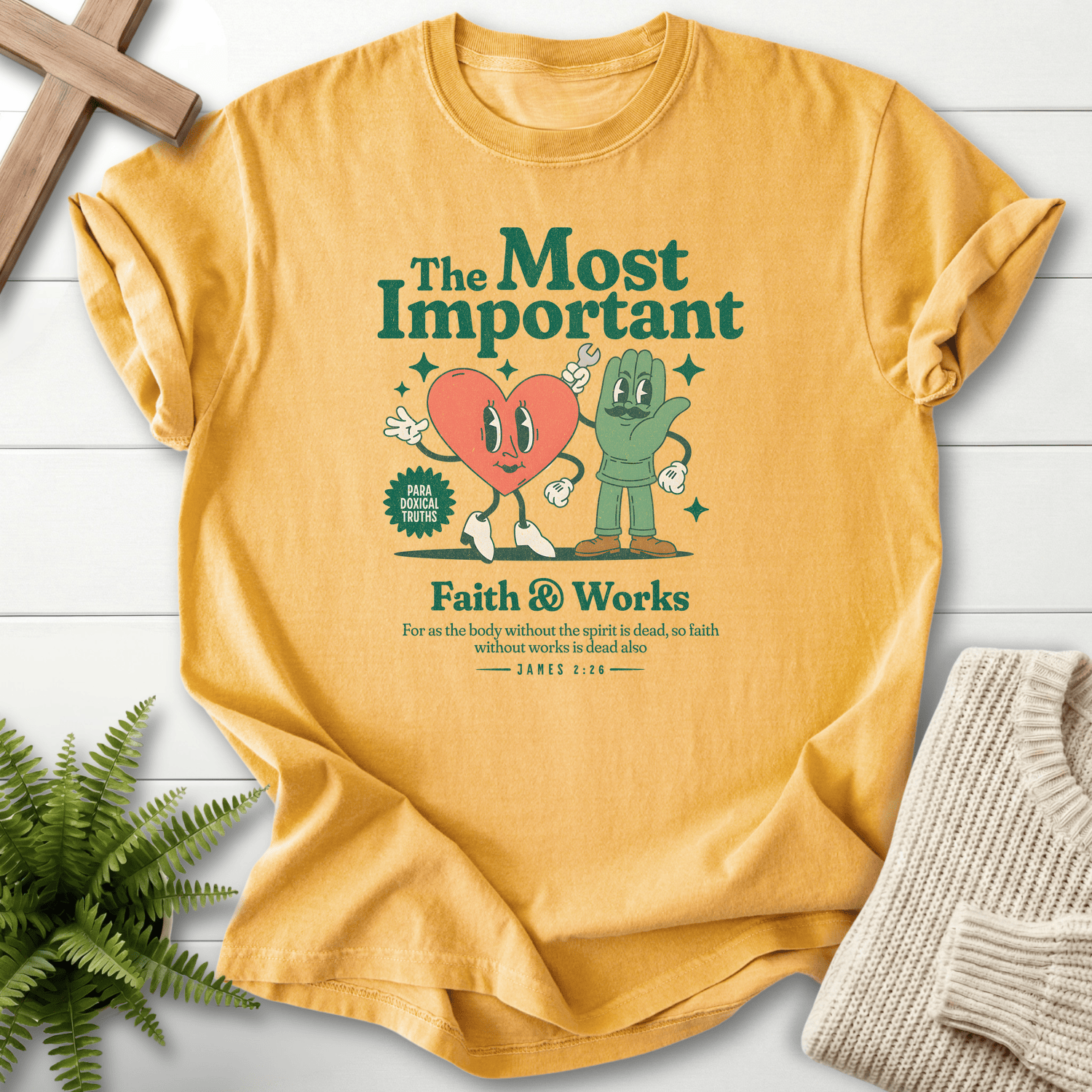 Mustard women's faith t-shirt with retro cartoon heart and hand characters and a groovy 'Faith and Works' badge, inspired by James 2:26.