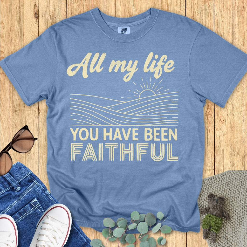 Comfort Colors 1717 Christian women t-shirt in blue jean flat lay on wood background. Inspirational text reads “All my life you have been faithful” with sun and waves motif