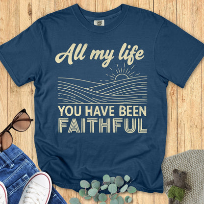 Comfort Colors 1717 Christian women t-shirt in midnight navy flat lay on wood background. Design features the phrase “All my life you have been faithful” with line art of sunrise.