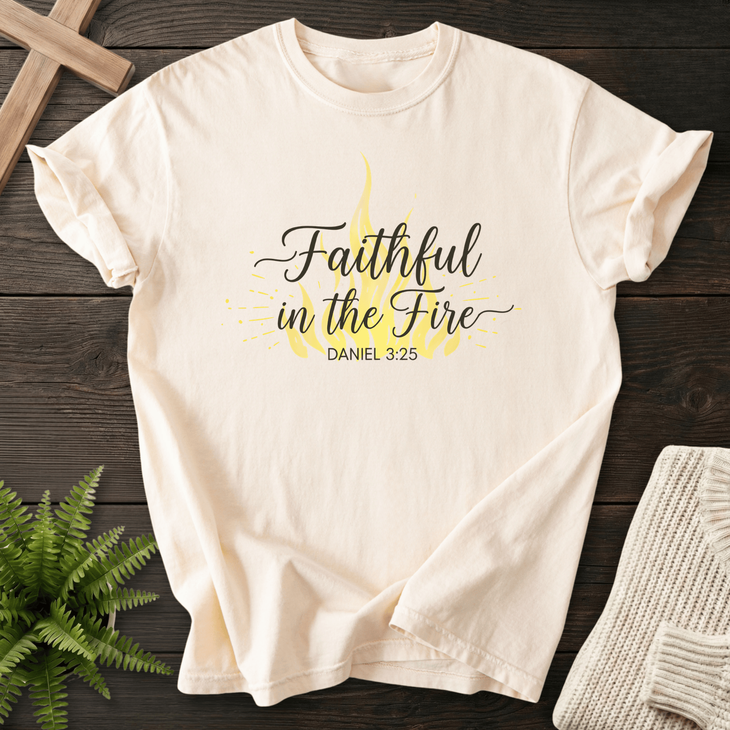 Ivory women's faith t-shirt with a yellow flame and script design, inspired by Daniel 3:25.