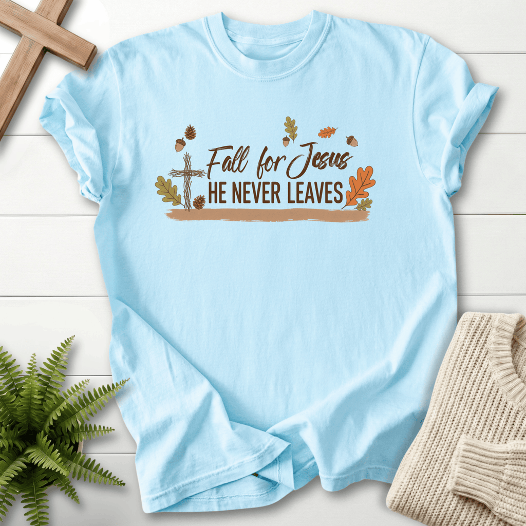Chambray women's faith t-shirt with a rustic cross and autumn leaf design around 'Fall for Jesus He Never Leaves'.