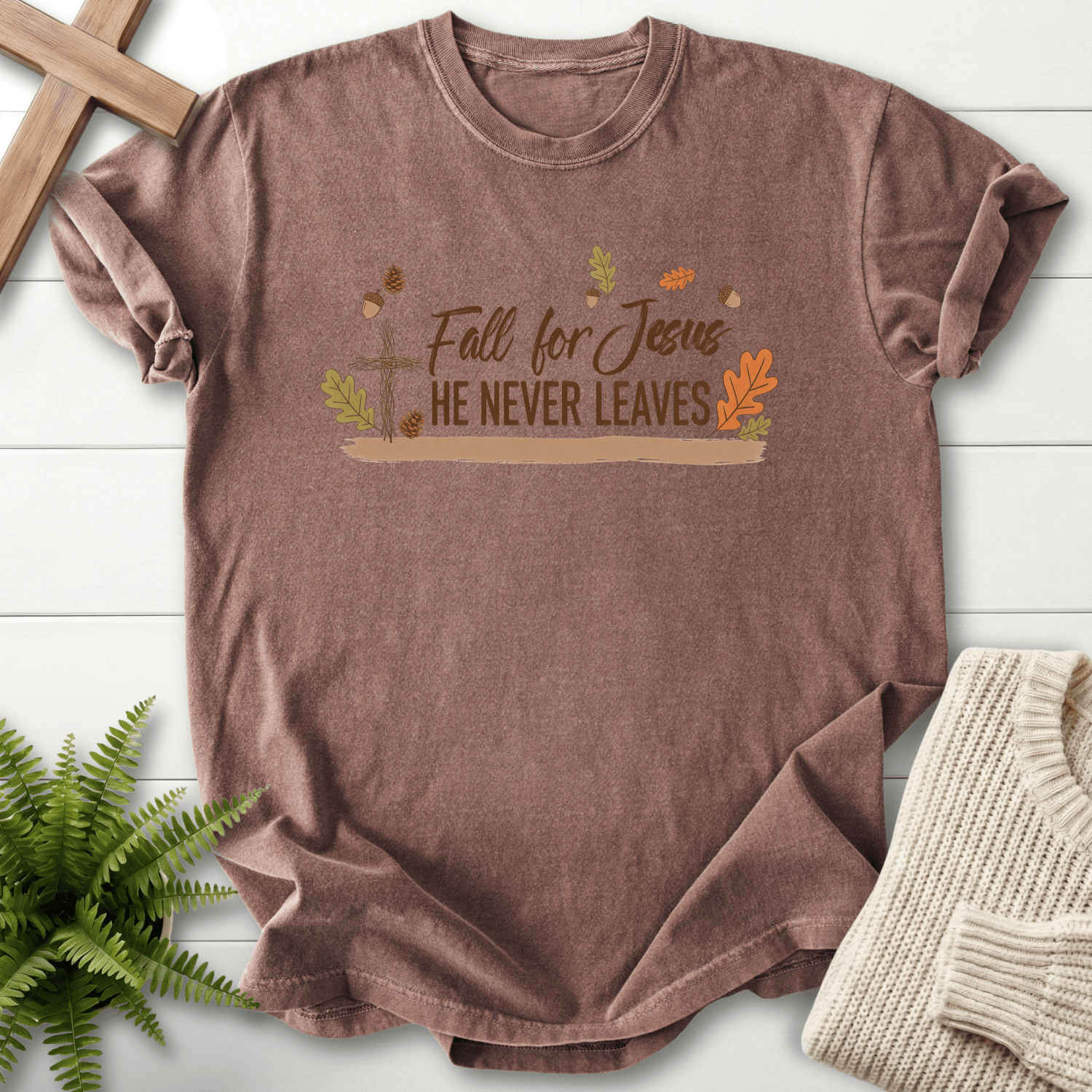 Espresso women's faith t-shirt with a wooden cross, scattered fall leaves, and acorns, plus 'Fall for Jesus He Never Leaves', Comfort Colors 1717.