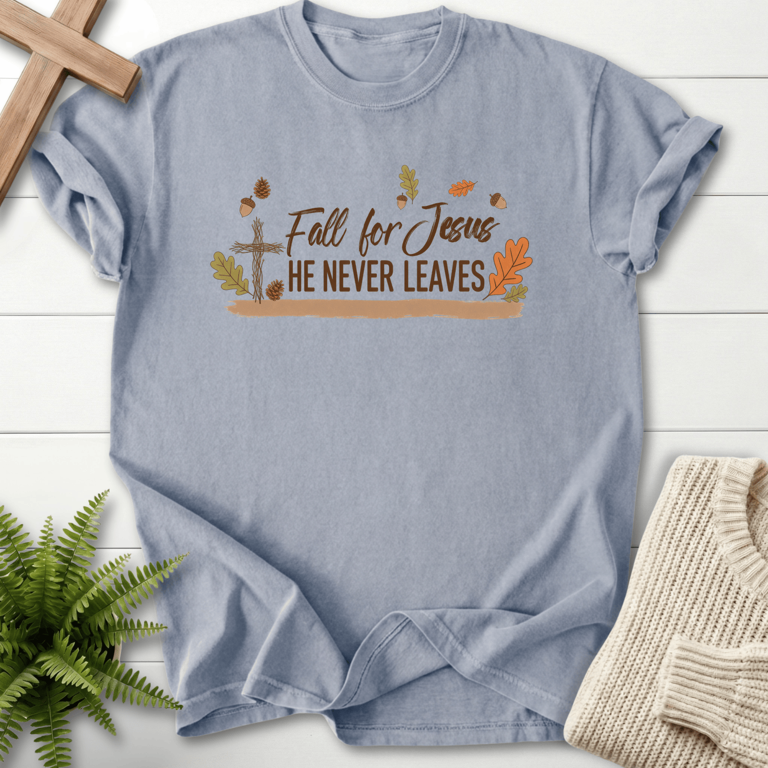 Granite women's faith t-shirt with a wooden cross, seasonal fall leaves, and 'Fall for Jesus He Never Leaves'.