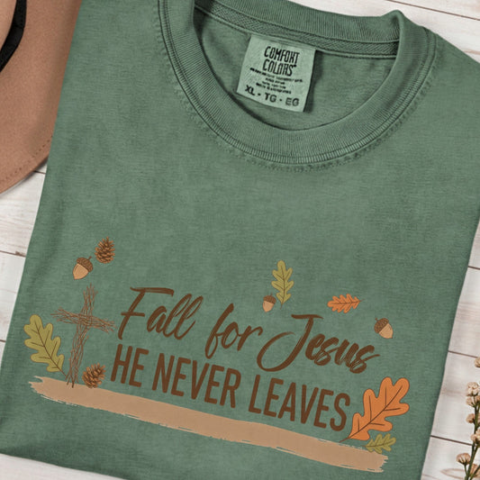 Fall for Jesus graphic printed on a moss green Comfort Colors 1717 t-shirt. A cozy Christian women t-shirt with autumn leaves and cross design — perfect to wear your faith this fall.