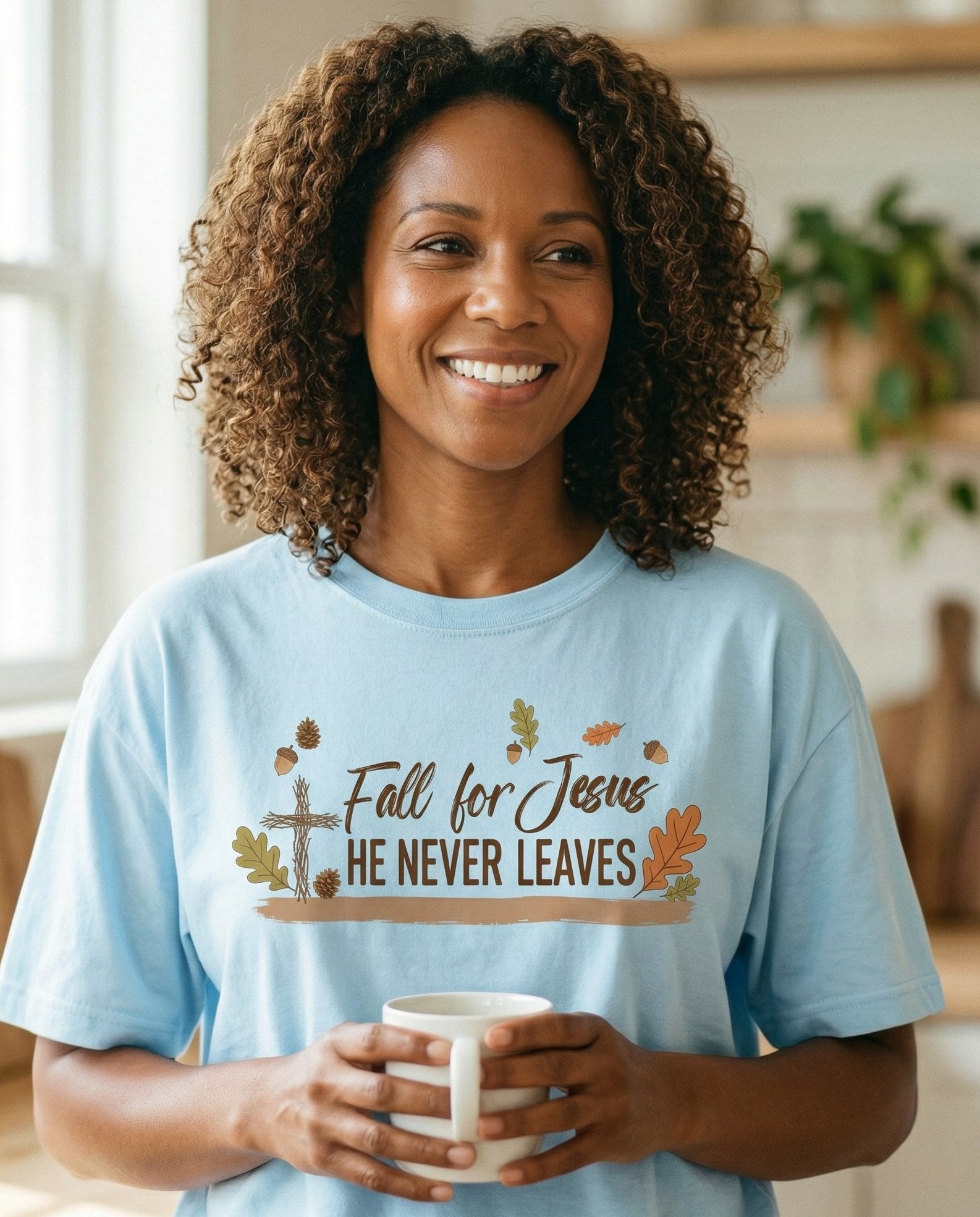 Fall for Jesus – Chambray women's Christian tee, lifestyle photo in morning kitchen setting – Autumn-themed graphic with a wooden cross – She Wears Faith
