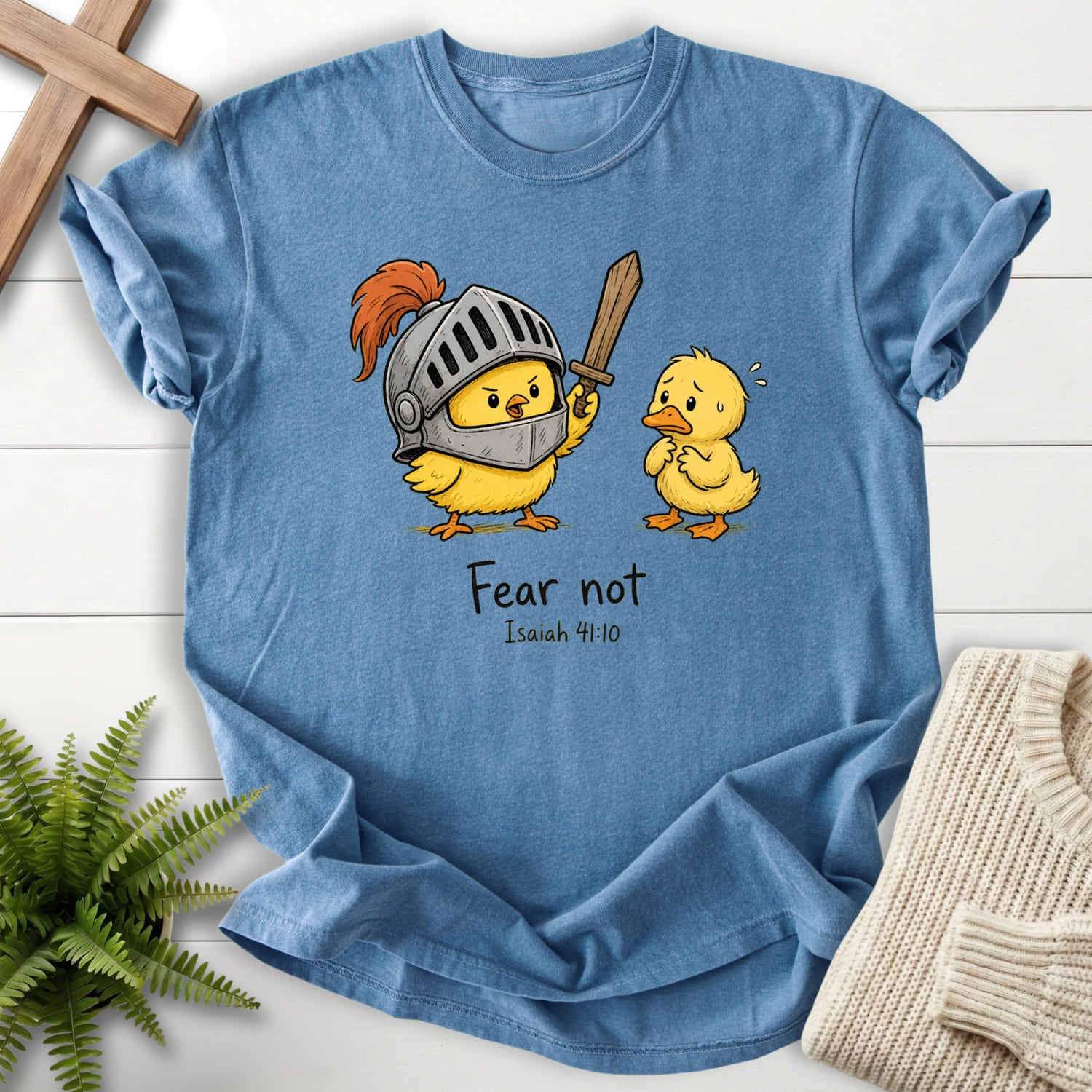 Flatlay of a Blue Jean faith-inspired shirt with "Fear Not Isaiah 41:10 Chick T-Shirt" Isaiah 41:10.