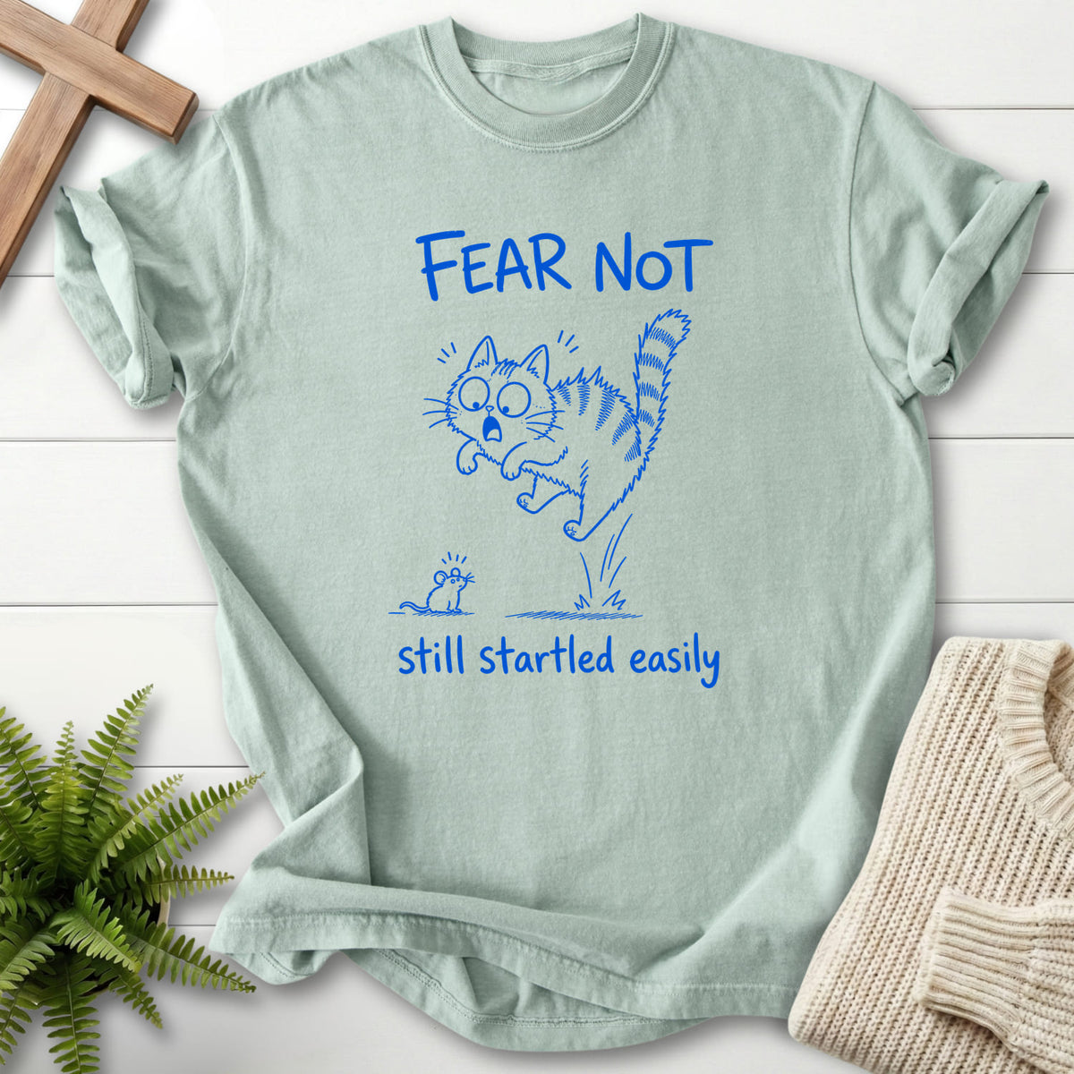 Flat lay of a Bay Christian shirt featuring "Fear Not Still Startled Easily T-Shirt" design.