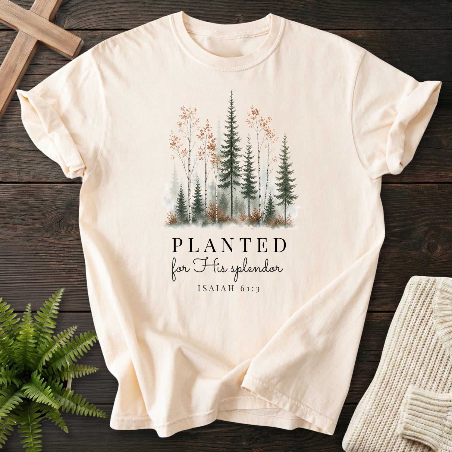 Flatlay of an Ivory faith-inspired shirt with watercolor artwork with "Planted for His Splendor T-Shirt" Isaiah 61:3.