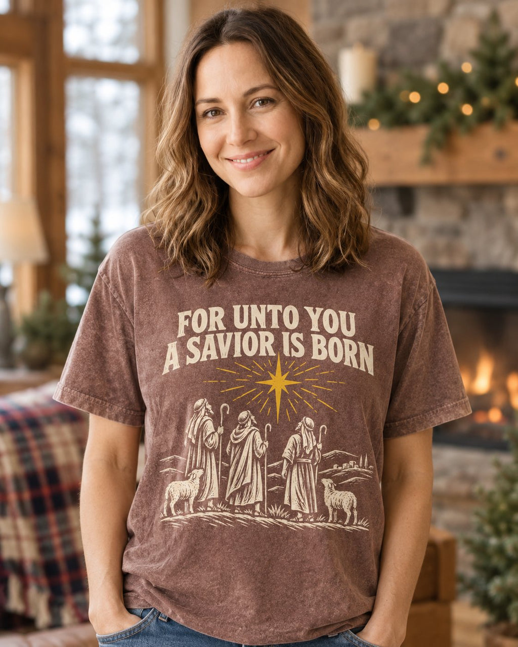 For Unto You a Savior Is Born, Espresso women's Christian tee, lifestyle photo in cozy cabin by the fireplace, FOR UNTO YOU A SAVIOR IS BORN with a star and shepherds, She Wears Faith