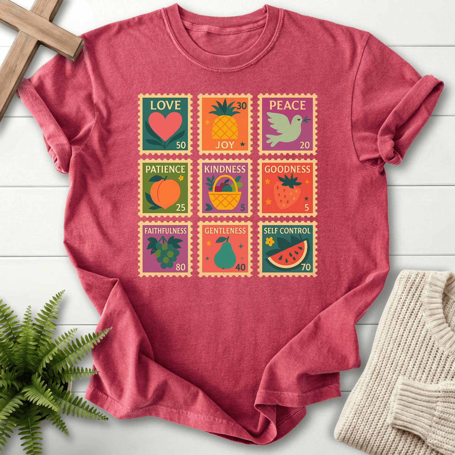 Crimson women's faith t-shirt with a vibrant nine-stamp Fruit of the Spirit design and bold fruit illustrations.