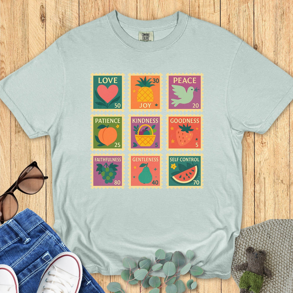 Comfort Colors Christian T-shirt in bay teal shown in a flat lay, with a bold Fruit of the Spirit stamp grid featuring colorful fruit icons and virtues: love, joy, peace, patience, kindness, goodness, faithfulness, gentleness, and self-control.